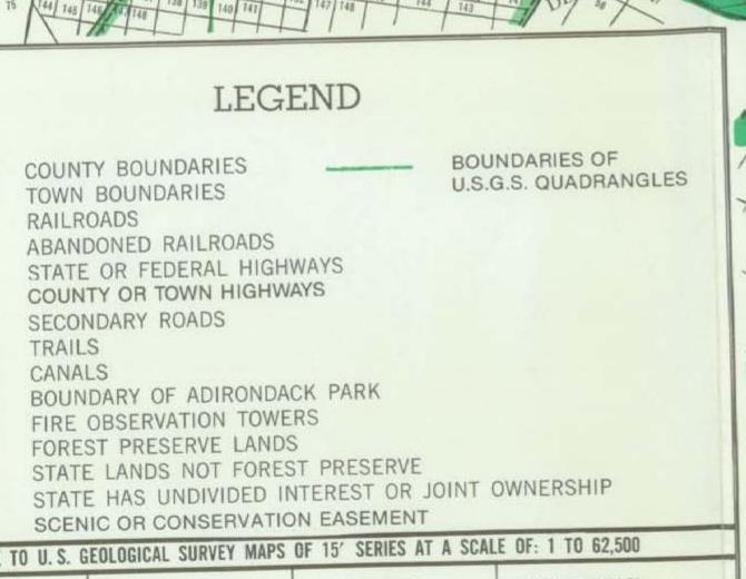 Legend from the DEC Adirondack Map listing symbols for county and town boundaries, railroads, highways, trails, fire observation towers and Forest Preserve lands.